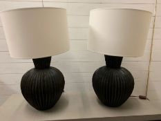 A pair of contemporary Constance lamps curved pleats that reference origami