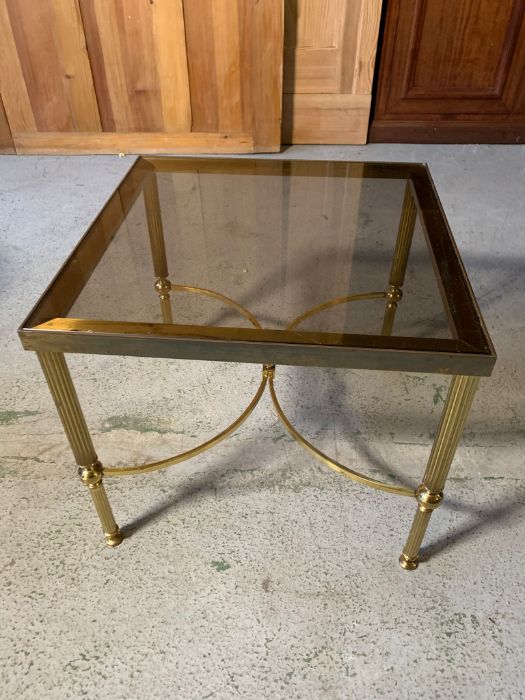 A smoked glass column table with one other