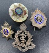 A selection of four silver military sweetheart brooches.