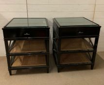 A pair of Eichholtz Bahamas side tables. Black lacquered and glass topped bedsides or side tables.