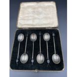 A boxed set of six silver coffee spoons with coffee bean ends by Cross Brothers and hallmarked for