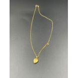 A 9ct gold chain with heart shaped locket (Total weight 2.7g)