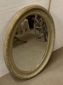 A pair of contemporary sage oval bevel edged mirrors (87 cm x 65cm)