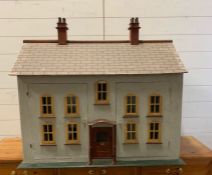 A vintage large wooden dolls house