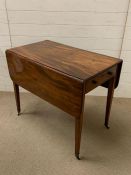 A mahogany Pembroke table with frieze drawer and one working drawer on square tapering legs with