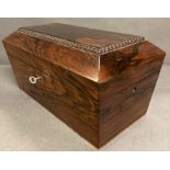 A Rosewood sarcophagus shape tea caddy, the interior with a pair of hinged lidded canisters AF