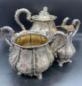 A substantial Victorian silver tea service with sugar bowl, milk jug and teapot by IW hallmarked for