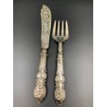 A pair of Victorian silver fish servers by FH, hallmarked for London 1847.