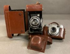 A Volgtlander 35mm camera and a Ensign Selfix 420 both in leather cases