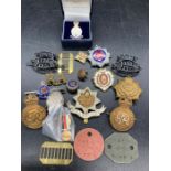 A selection of military badges, insignia etc.