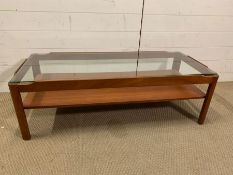 A two tier Mid Century Myer coffee table with clear glass (H36cm W112cm D49cm)