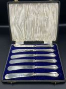 A Boxed set of of silver handled butter knives, hallmarked for Sheffield 1935 by John Biggin