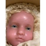 A vintage wax head doll