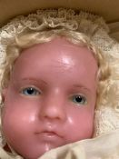 A vintage wax head doll