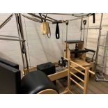 A Pilates reformer with full trapeze table complete with springs, shop and push through bar,