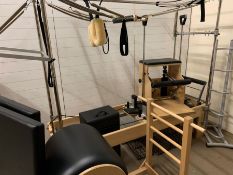 A Pilates reformer with full trapeze table complete with springs, shop and push through bar,