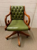 A button back swirl desk chair with scrolling arms and down swept legs