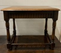 An jointed oak side table/stool on turned legs