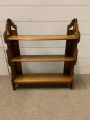 An oak hanging wall shelf with pierced sides (H64cm W57cm D14cm)