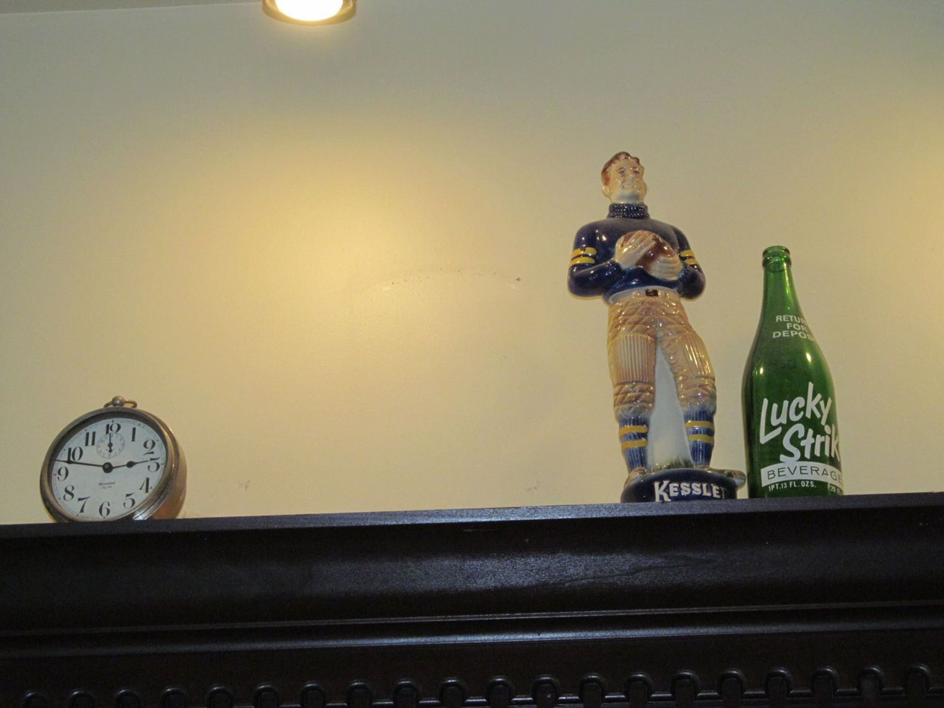 Lot - Clock, Porcelain Football Figure, Bottles, and Tin (Billiards Room)