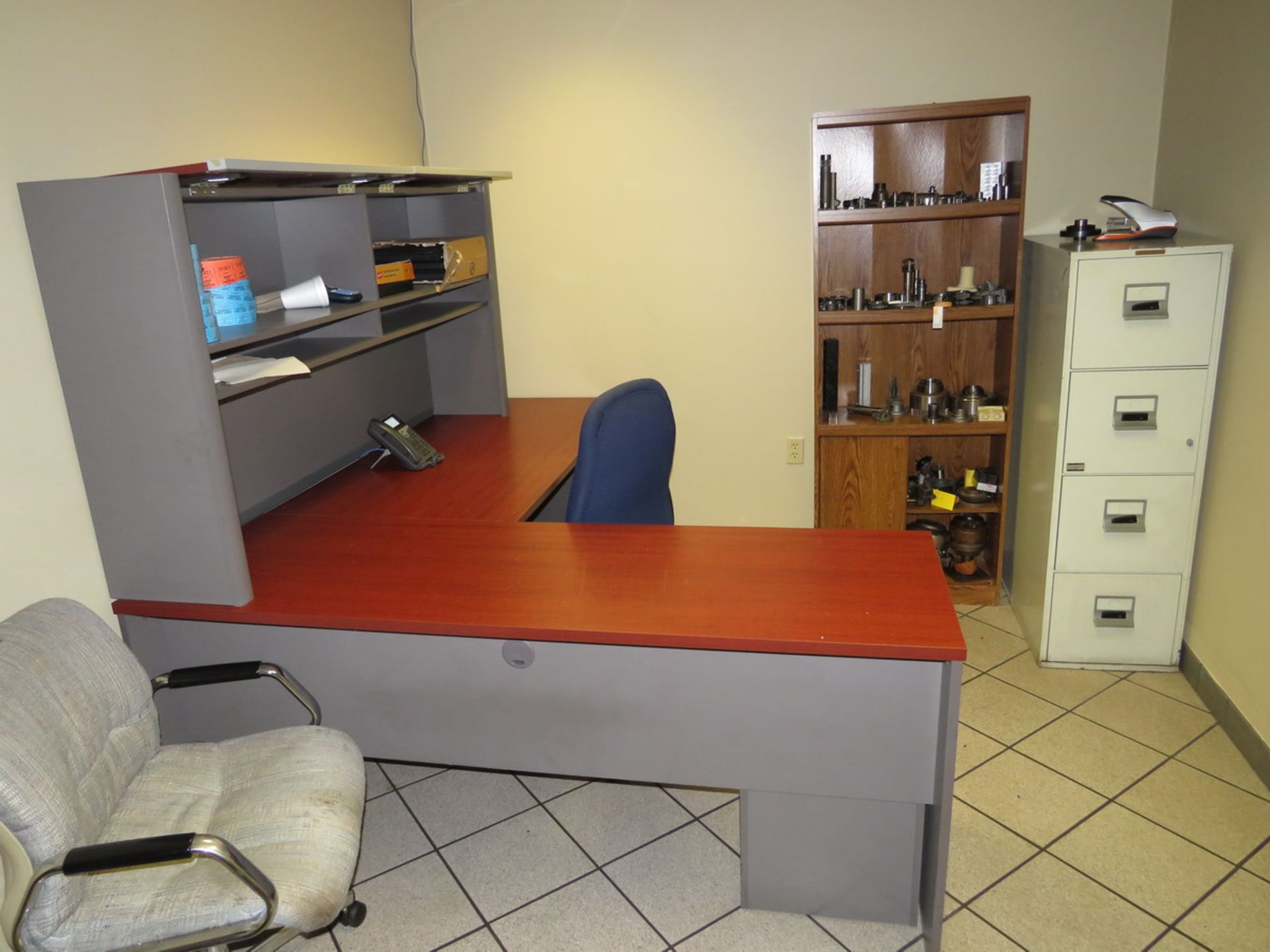 Contents of Office to Include: L-Shaped Desk, Bookshelf, 4-Drawer Metal Vertical Filing Cabinet,