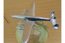 BEAUTIFUL MODEL OF POLISHED ALUMINIUM 4 ENGINE AIRCRAFT MOUNTED ON TOP OF HIGH QUALITY GLOBE