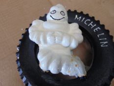 CAST IRON MICHELIN MAN SITTING IN A TYRE 20cms x 21cms