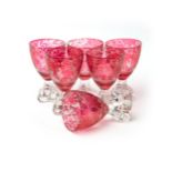 Six cranberry flash glass drinking goblets with romanticised scenes