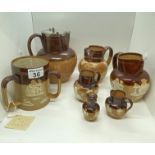 A quantity of antique Doulton Lambeth ware jugs/pitchers/vessels in various sizes including ; a