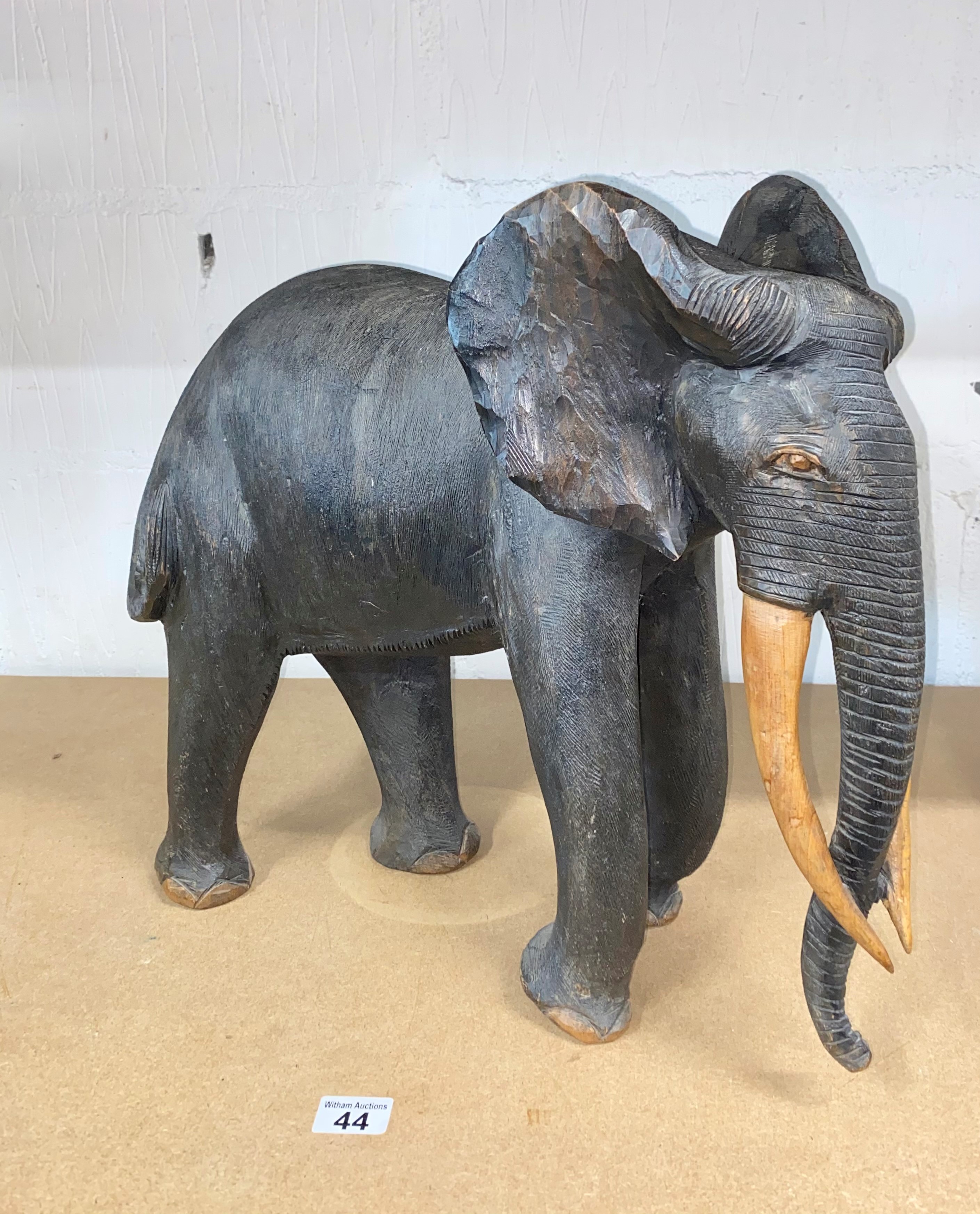 Hand carved hardwood African Elephant in standing stance, approx. H46cm, A/F to ear