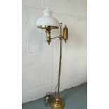 Standard brass floor lamp converted to electric, with glass funnel and glass shade
