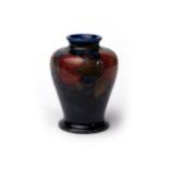 Moorcroft - small baluster vase with pomegranate design on blue, impressed Moorcroft Burslem to base