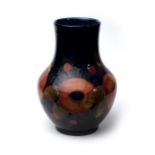 William Moorcroft Pomegranate design vase on blue ground, with blue Moorcroft signature impressed