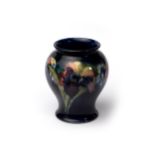 Moorcroft cobalt blue vase with floral orchid design, impressed signature W Moorcroft Potter to HM