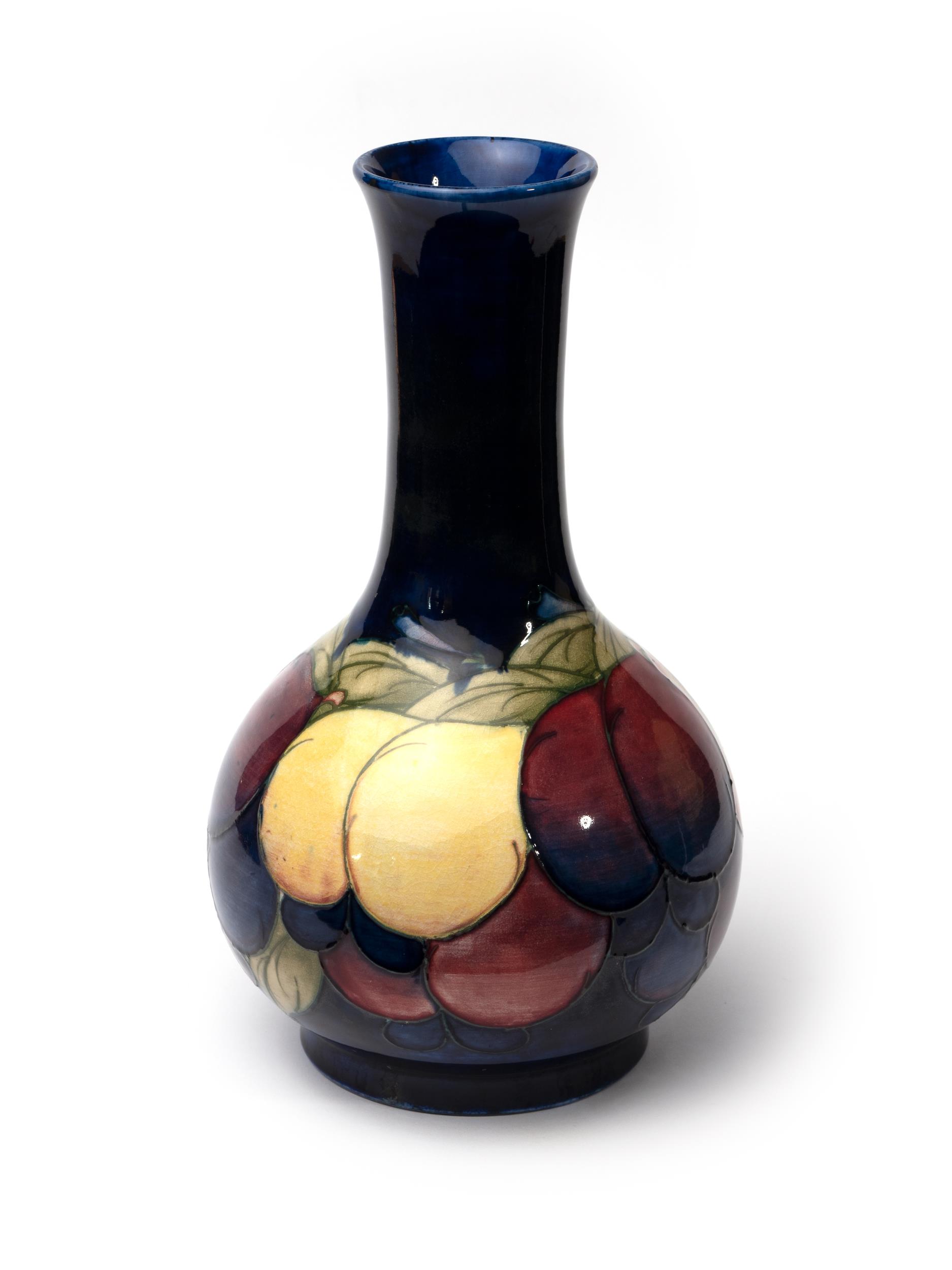 William Moorcroft wisteria design vase on blue ground, with blue William Moorcroft signature and