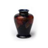 Moorcroft - small baluster vase with pomegranate design on blue, impressed Moorcroft Burslem to base