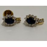 A pair of 18ct yellow gold sapphire and diamond cluster earrings, approx gross s1ct, d0.60.