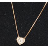 A 14ct yellow gold heart shaped pendant (tested as 14ct gold) infilled with diamonds with 14k gold