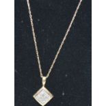 A 10k yellow gold Diamond pendant of nine diamonds set into rectangular design with gold chain, both