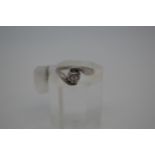 18ct white gold ring with central diamond stone 0.10ct in a swirl design, Hallmarked 18ct