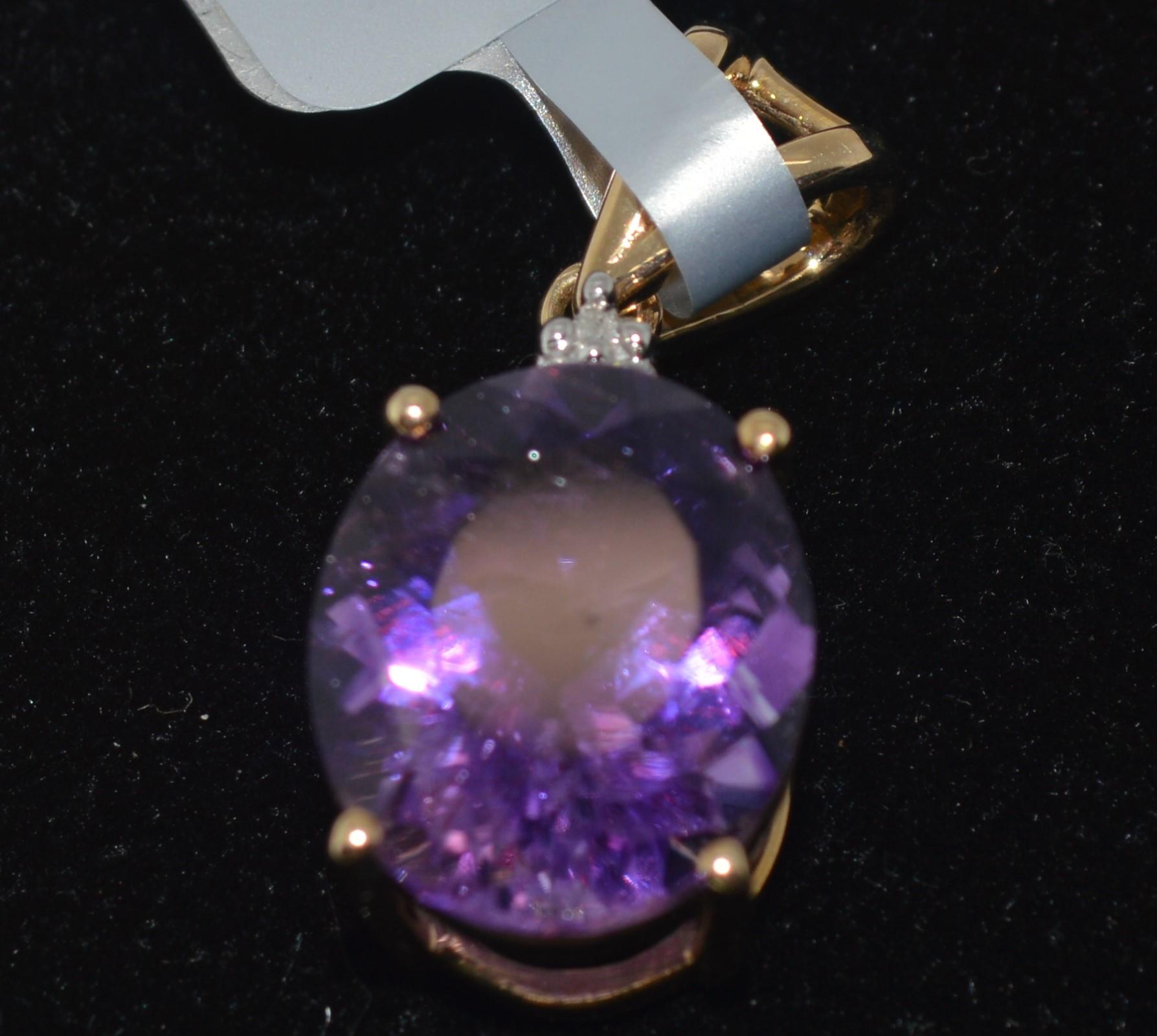 X2 amethyst gem stones pendants set in gold mounts marked 417 TGGC