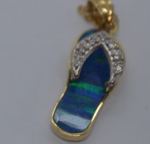 A yellow gold pendant in the form of a flip flop with diamond detailing to the design, stamped 14K
