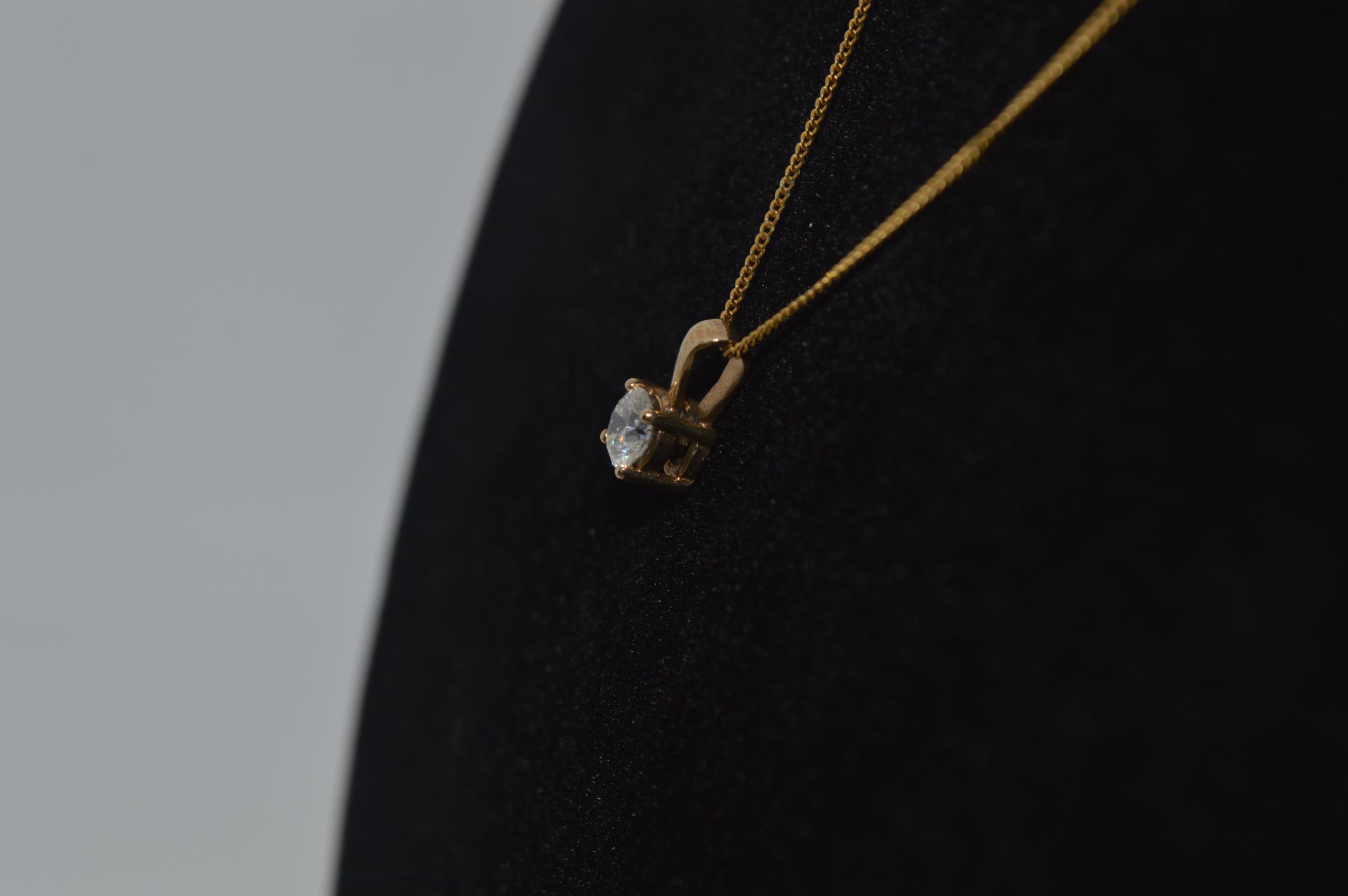Yellow gold necklace with 0.33ct diamond solitaire pendant marked as 9ct gold