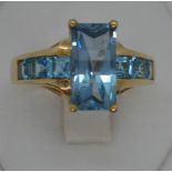 9ct yellow gold ring with faceted rectangular blue stone - possibly topaz, with co-ordinating square