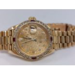 Rolex – A ladies genuine 18ct yellow gold Datejust wristwatch encrusted with diamonds and rubies,