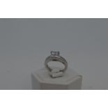 18ct white gold diamond ring in square from central design with x10 accent diamonds to shoulder,