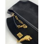 Gucci black suede shoulder bag, with a gold-tone tiger's head clasp and black leather detailing,
