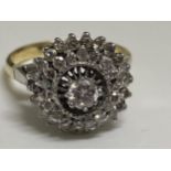 A 18ct gold dress ring, graduating raised mount design with approx .20ct raised central stone with