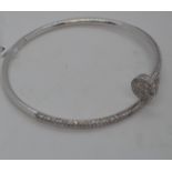 A 18ct white gold hinged bracelet featuring 2.64ct diamonds, approx gross weight 17.5g. This item