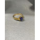 18ct yellow gold ring with claw setting encapsulating oval semi precious blue stone, approx size